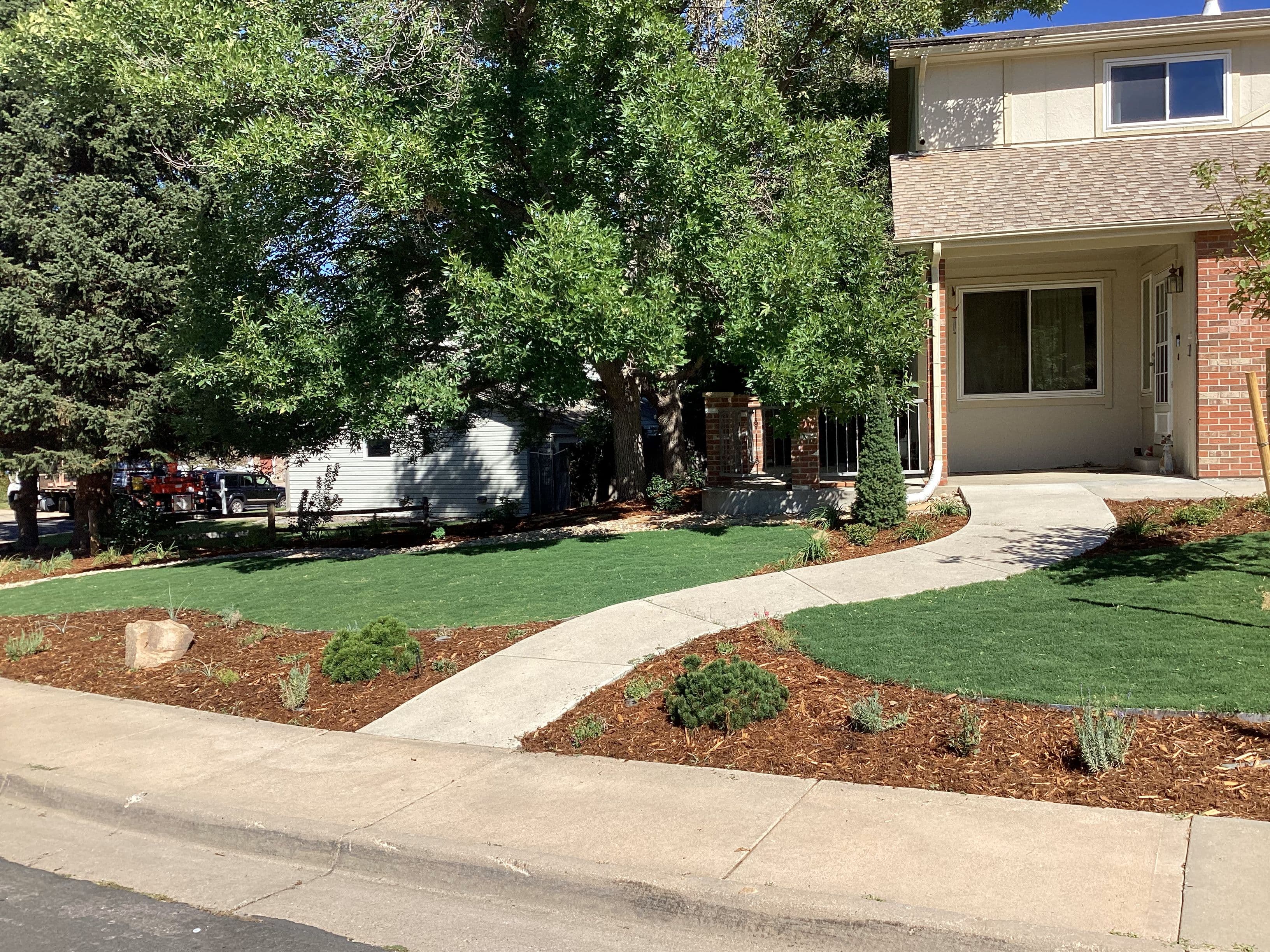 A finished front entry with new planting beds, mulch and a curved walk