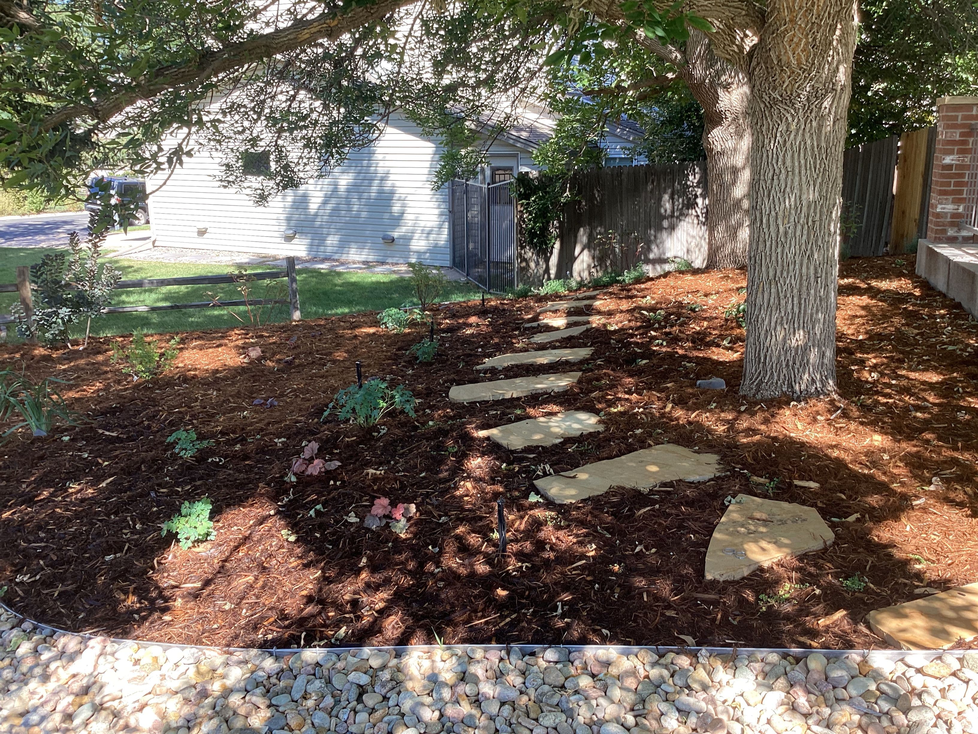 Turf replaced with mulched planting beds and flagstone stepping stones